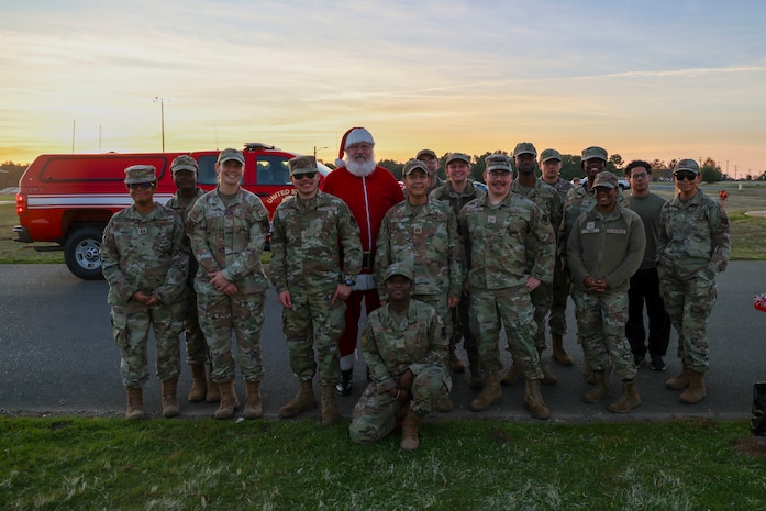 Santa Claus poses for a photo with members of the Beale Spiritual Intelligence Surveillance and Reconnaissance (ISR) team during the annual Christmas Tree lighting at Beale Air Force Base, California, Dec. 6, 2024.