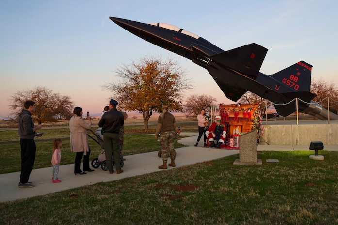 Santa Claus poses for photos with family members during the annual Christmas Tree lighting at Beale Air Force Base, California, Dec. 6, 2024.