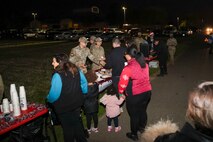 U.S. Air Force members of the Beale Spiritual ISR team give cookies to families during the annual Christmas Tree lighting at Beale Air Force Base, California, Dec. 6, 2024.