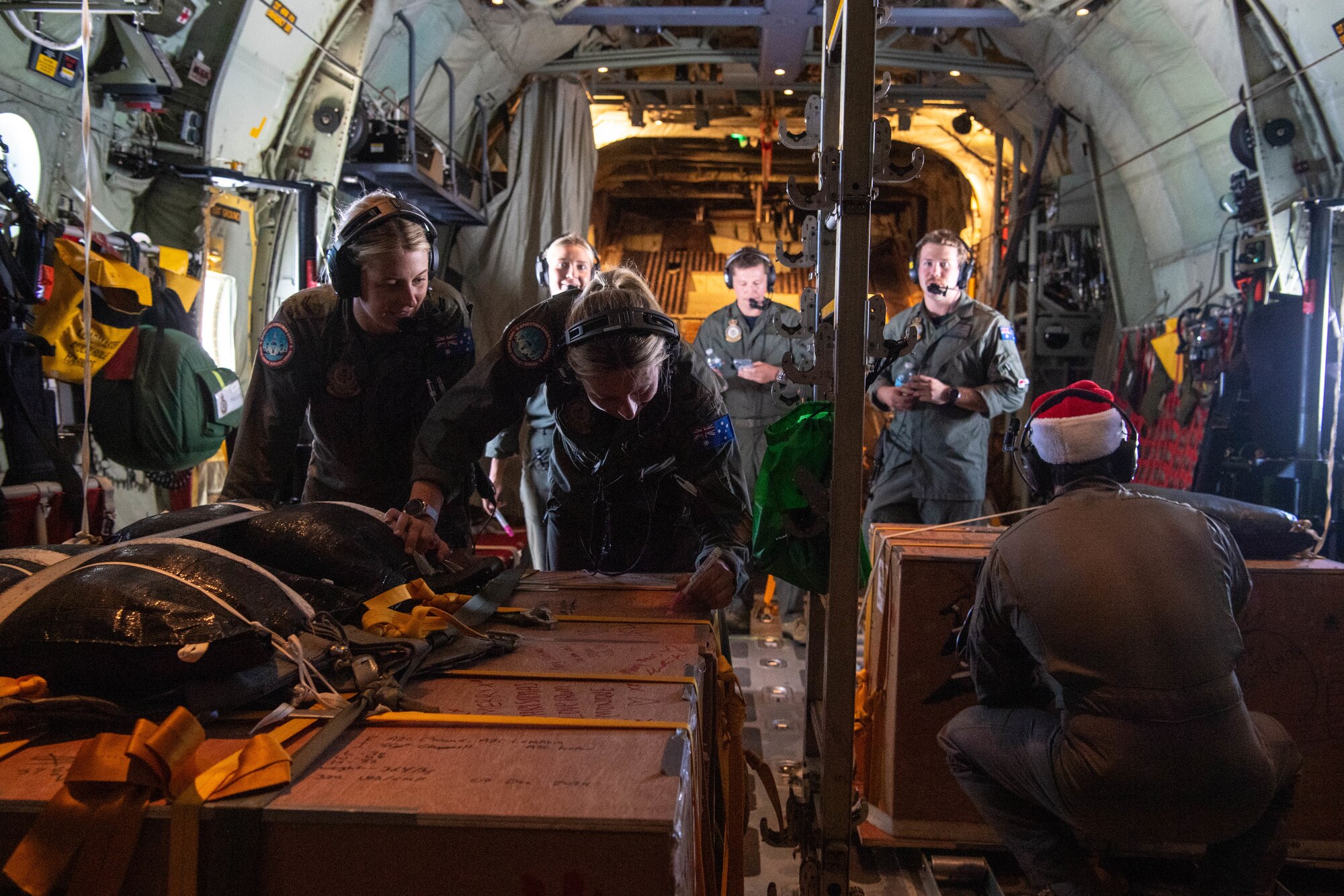 Airmen draw on a box.