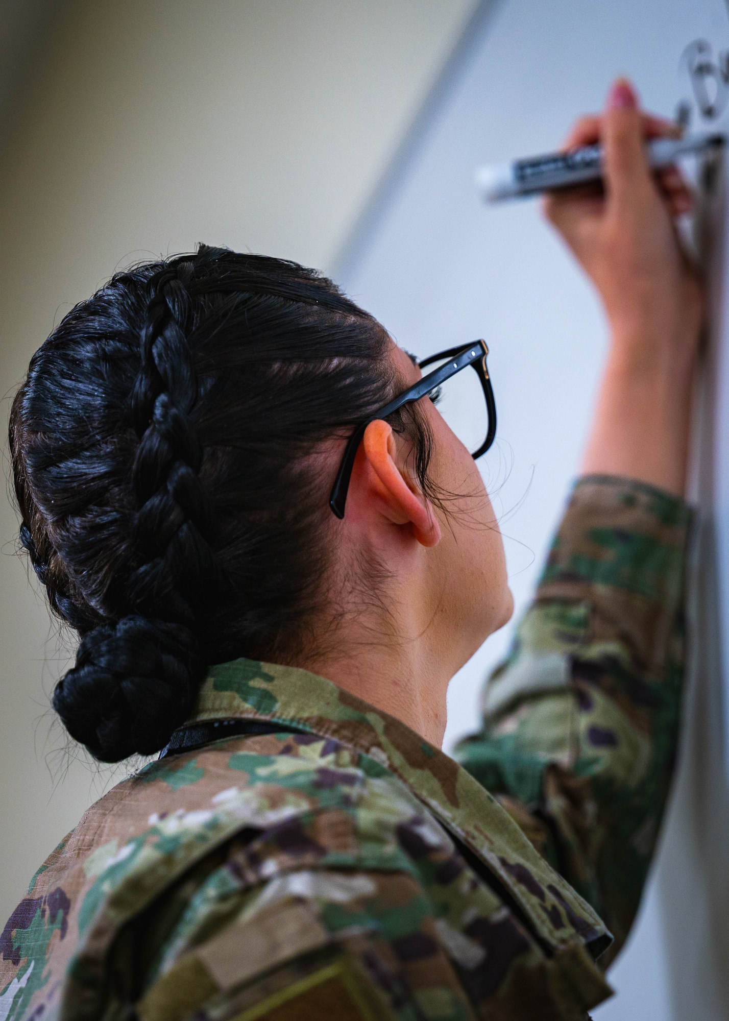 U.S. Air Force Tech. Sgt. Angel Von Scheffey, 56th Operations Support Squadron non-commissioned officer in charge of the F-16 Fighting Falcon Intelligence Formal Training Unit, writes key concepts on a board during a class.