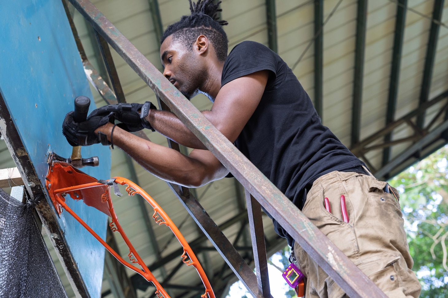 SUBIC, Philippines (Dec. 4, 2024) —Civilian mariner Phillip Watson, a wiper assigned to Military Sealift Command’s (MSC) dry cargo and ammunition ship USNS Charles Drew (T-AKE 10), removes a basketball rim at Aningway-Sacatihan Elementary School Annex/High School, during a community outreach event at Subic, Philippines, Dec. 4, 2024. The Aeta are indigenous people who live in scattered, isolated mountainous parts of Luzon, Philippines. MSC Far East supports the U.S. 7th Fleet and ensures approximately 50 ships in the Indo-Pacific Region are manned, trained, and equipped to deliver essential supplies, fuel, cargo, and equipment to warfighters, both at sea and on shore. (U.S. Navy photo by Grady T. Fontana)