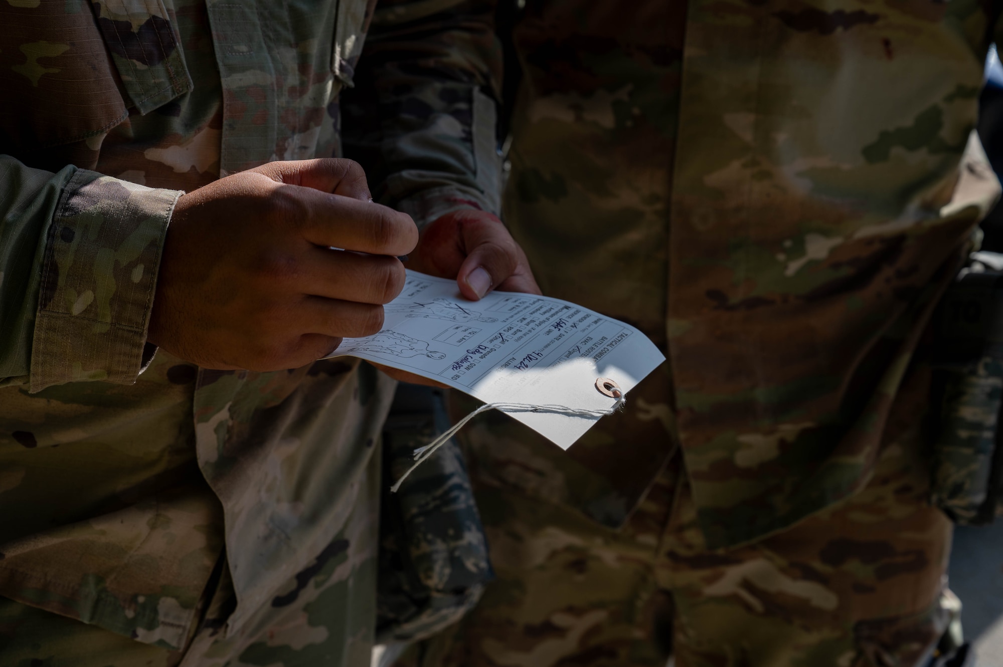 Service member writes on paper.