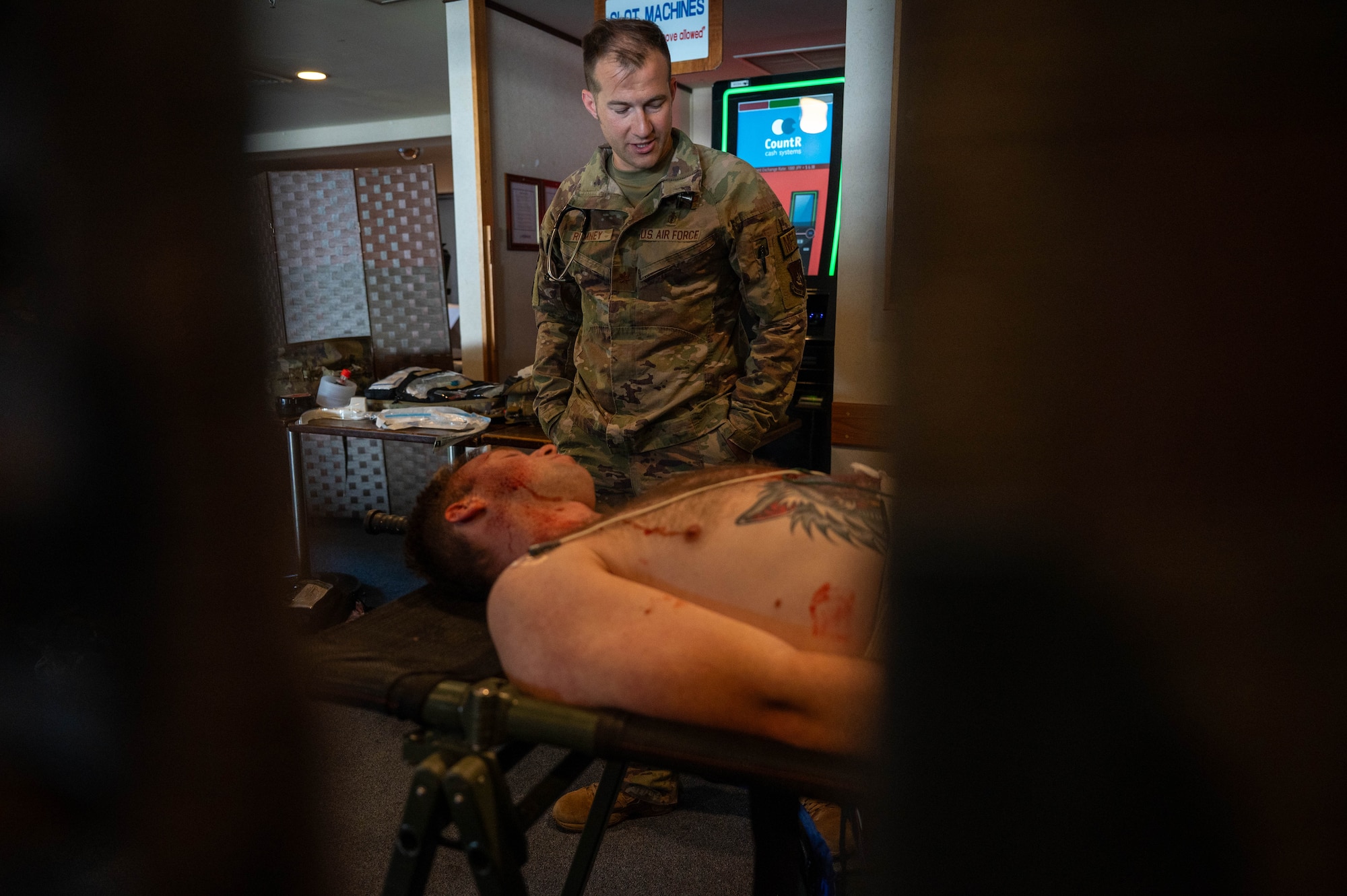 Service member assessing patient.