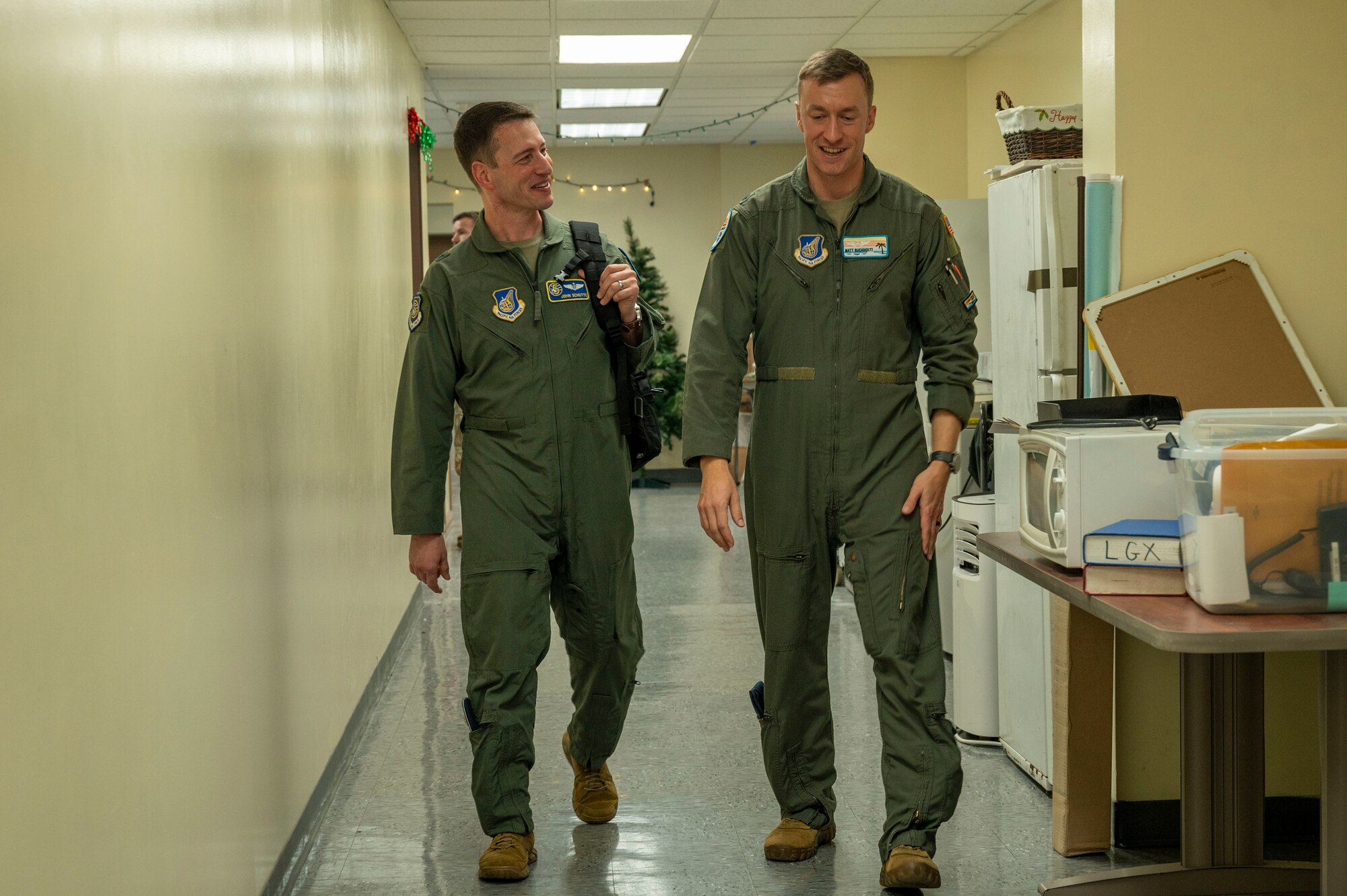 Service members walk through a hallway.