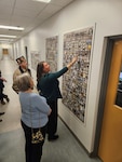 Dr. Carrie Brown, Defense POW/MIA Accounting Agency supervisory forensic anthropologist and laboratory manager, points out accounted for servicemembers that were identified during the agency’s USS Oklahoma Project during a tour for the Veterans of Foreign Wars Junior Vice Commander-in-Chief and Nebraska VFW leaders, who visited DPAA’s Offutt laboratory at Offutt Air Force Base, Nebraska, Dec. 3, 2024.