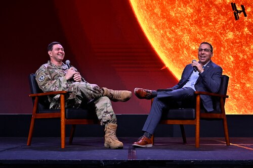 Gen. Saltzman and Gen. Liquori talking while sitting