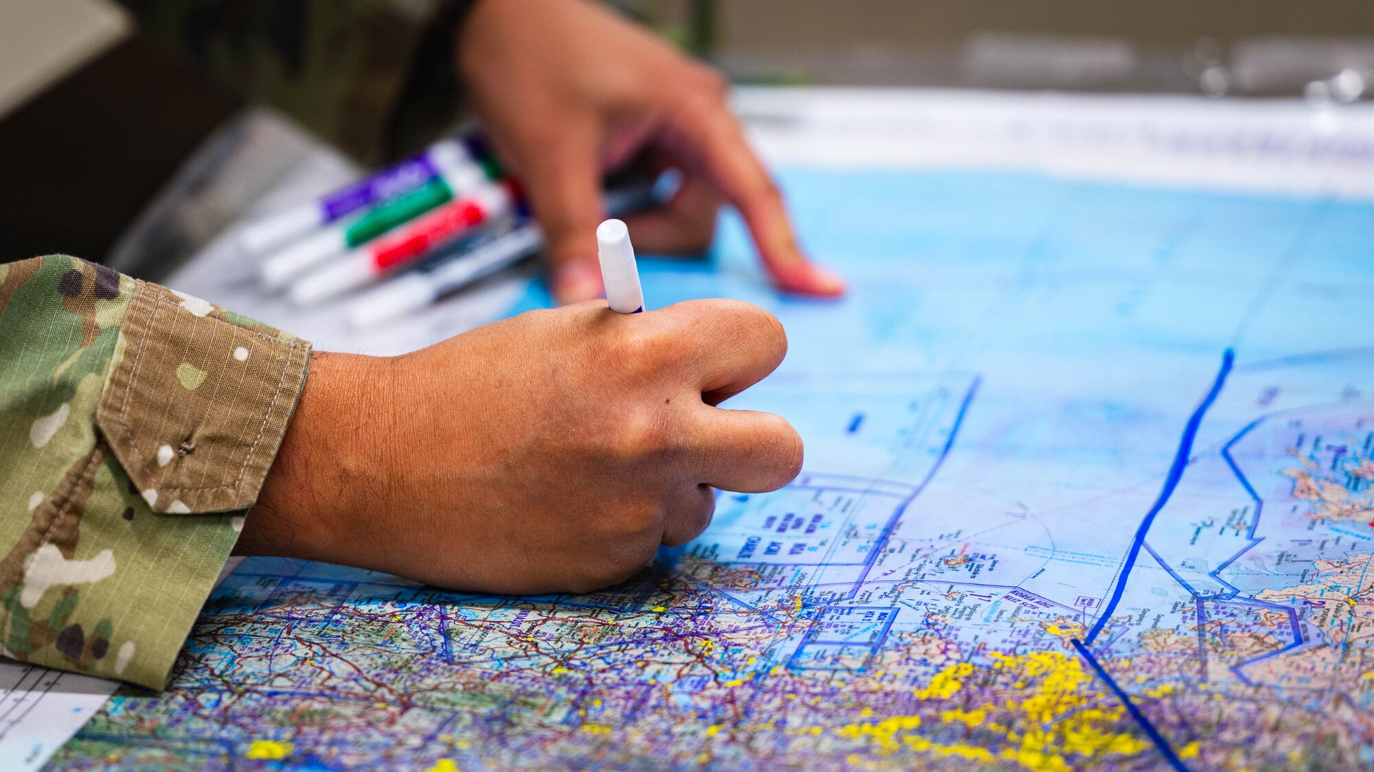 U.S. Air Force Tech. Sgt. Jose Pichardo, 56th Operations Support Squadron training cadre, takes notes on a map.