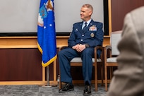 a man sits during a ceremony