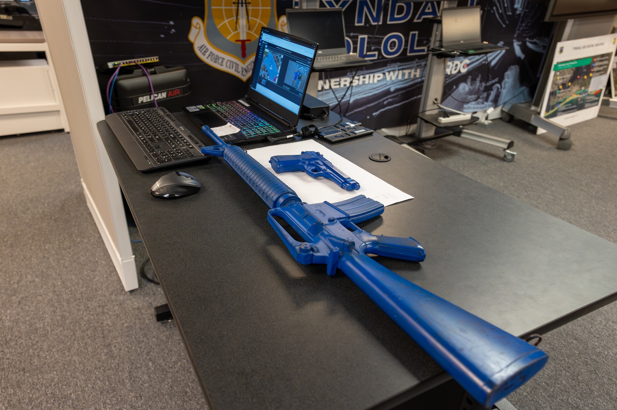 Prop firearms sit on a desk