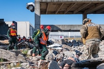 Louisiana Army National Guardsmen assigned to the Chemical, Biological, Radiological, Nuclear, and High Yield Explosive Enhanced Response Force Package check for contamination levels at a collapsed building at Guardian Centers of Georgia, Perry, Georgia, Dec. 3, 2024. The CERFP conducted a training exercise culminating in a National Guard Bureau evaluation Dec. 1–7.