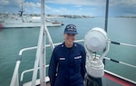 Petty Officer Third Class Elizabeth Montoro poses aboard a 270-foot Medium Endurance Cutter (MEC) while serving as Situation Unit Leader during Operation Vigilant Sentry (OVS) (U.S. Coast Guard photo courtesy of Petty Officer Third Class Elizabeth Montoro).