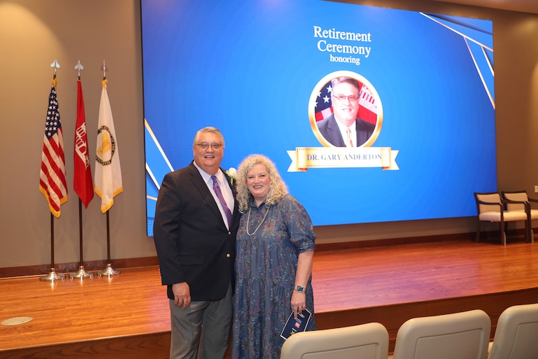 Dr. Anderton posses with his wife, Cheri, after thanking her and their two children for their support during his ceremonial speech.