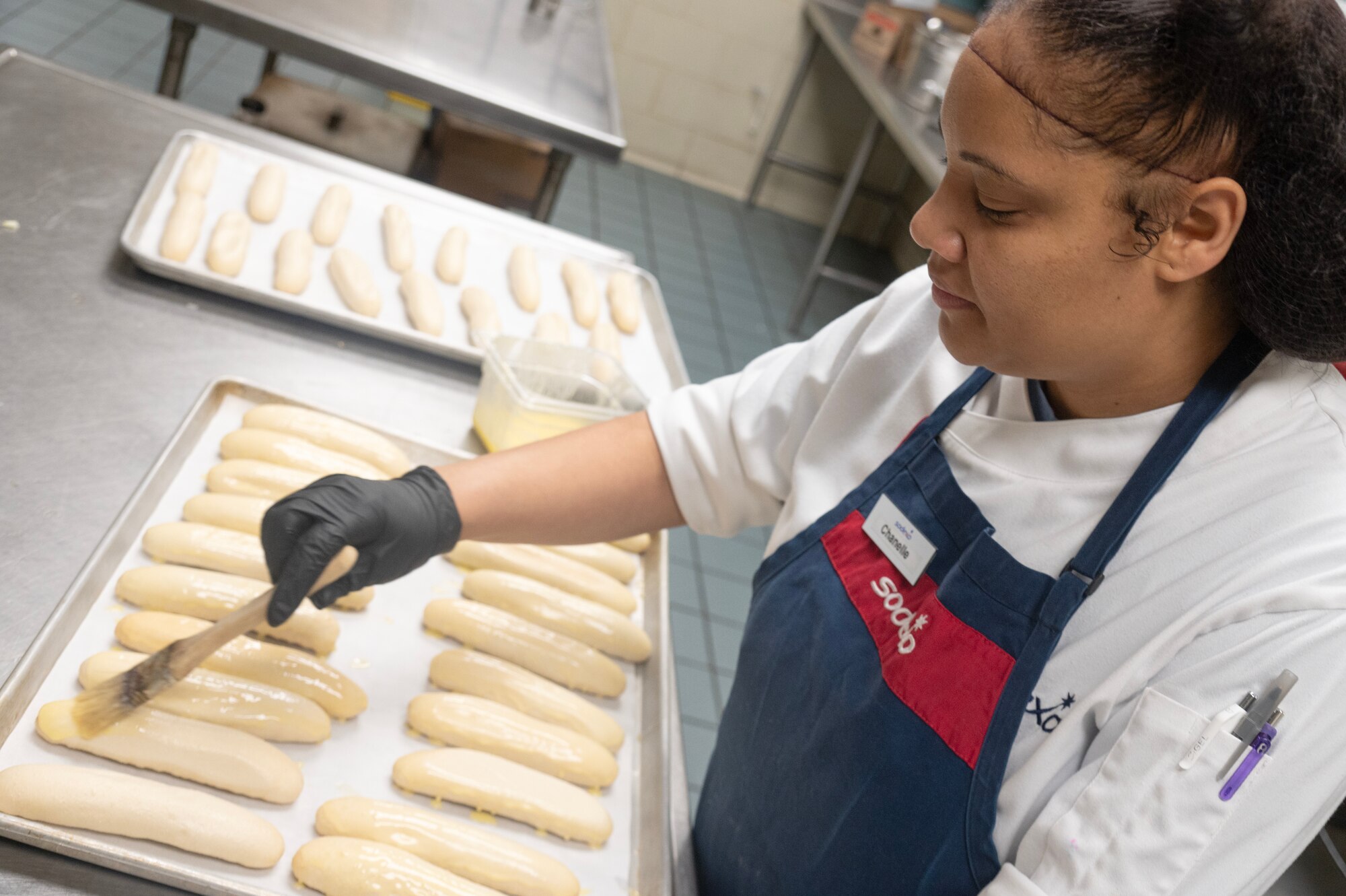 Chanelle Rodrigo, 4th Force Support Squadron Cook #2, butters bread in preparation to serve Thanksgiving meals.