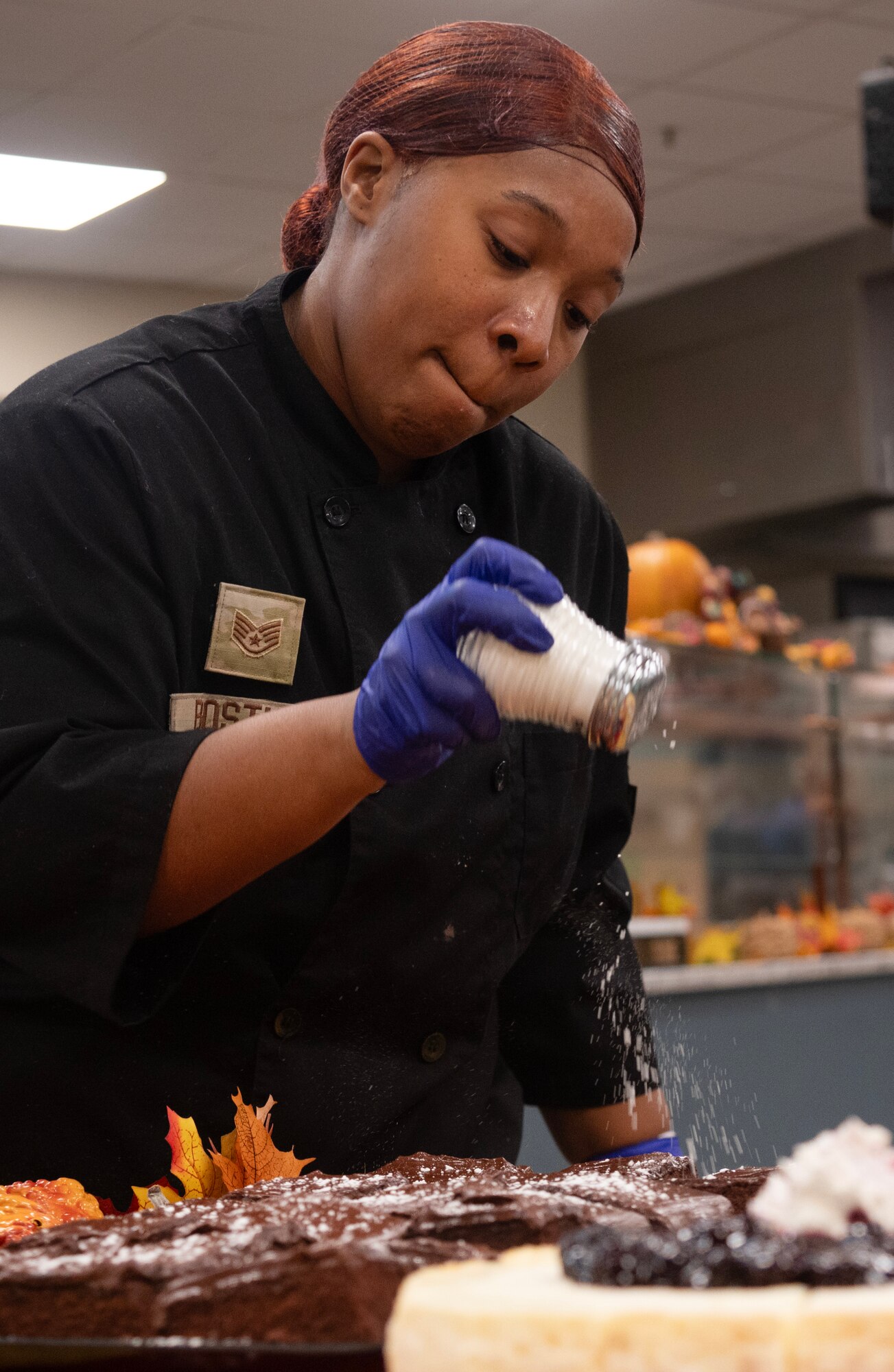 Staff Sgt. Angel Bostic, 4th Force Support Squadron food service journeyman, sets up a dessert table in preparation for a Thanksgiving meal.
