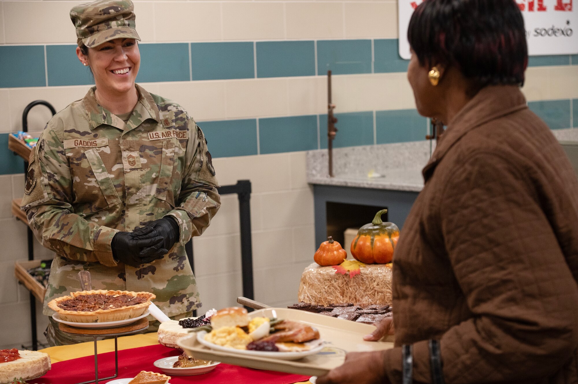 Chief Master Sgt. Cassie Gaddis, 4th Medical Group senior enlisted leader, helps serve desserts during a Thanksgiving meal.