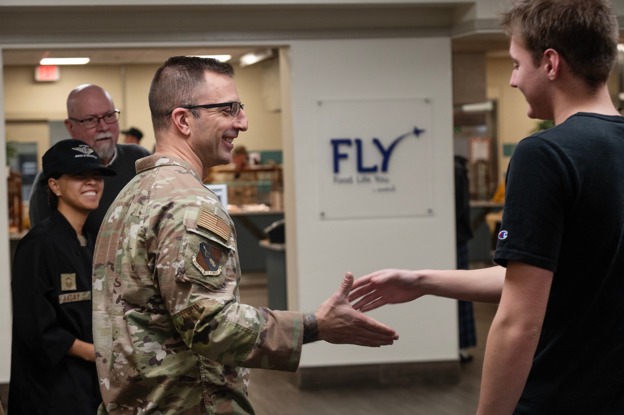 Chief Master Sgt. Paul Hammer, 4th Fighter Wing command chief, greets an Airman during a Thanksgiving meal at Seymour Johnson Air Force Base.