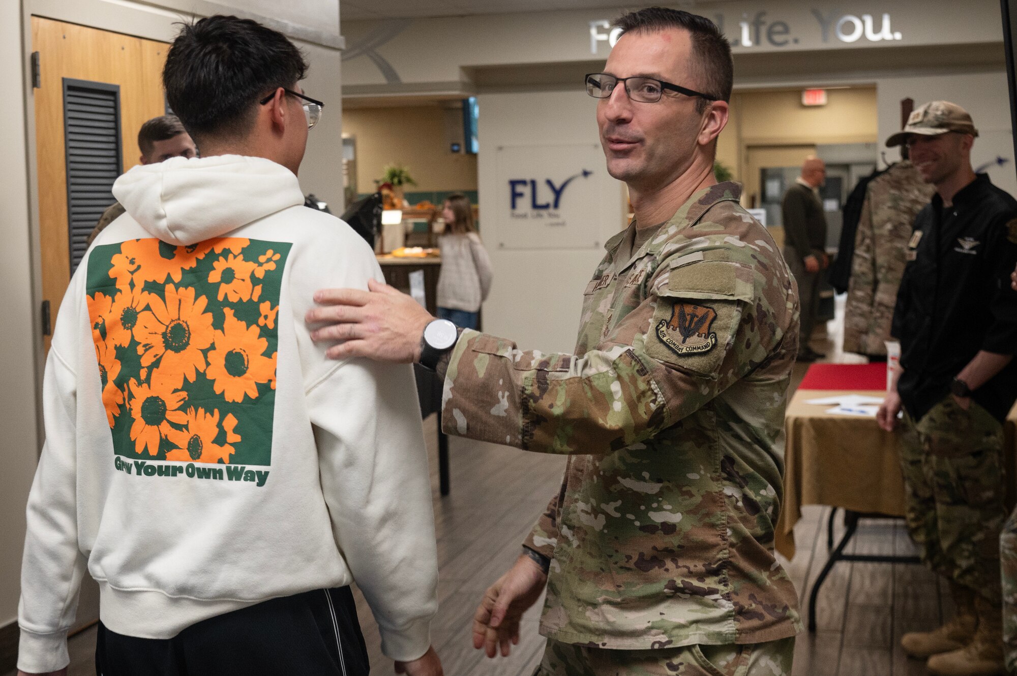 Chief Master Sgt. Paul Hammer, 4th Fighter Wing command chief, greets an Airman during a Thanksgiving meal at Seymour Johnson Air Force Base.