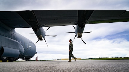 USAF Captain walks by an aircraft when conducting a post flight inspection during Operation Christmas Drop