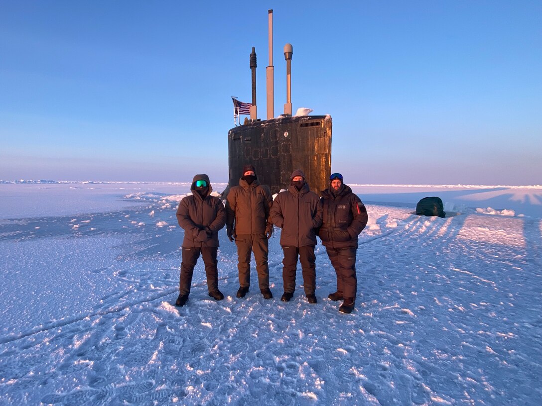 Naval Surface Warfare Center, Carderock Division engineers take photo in front of submarine in the Arctic Ocean