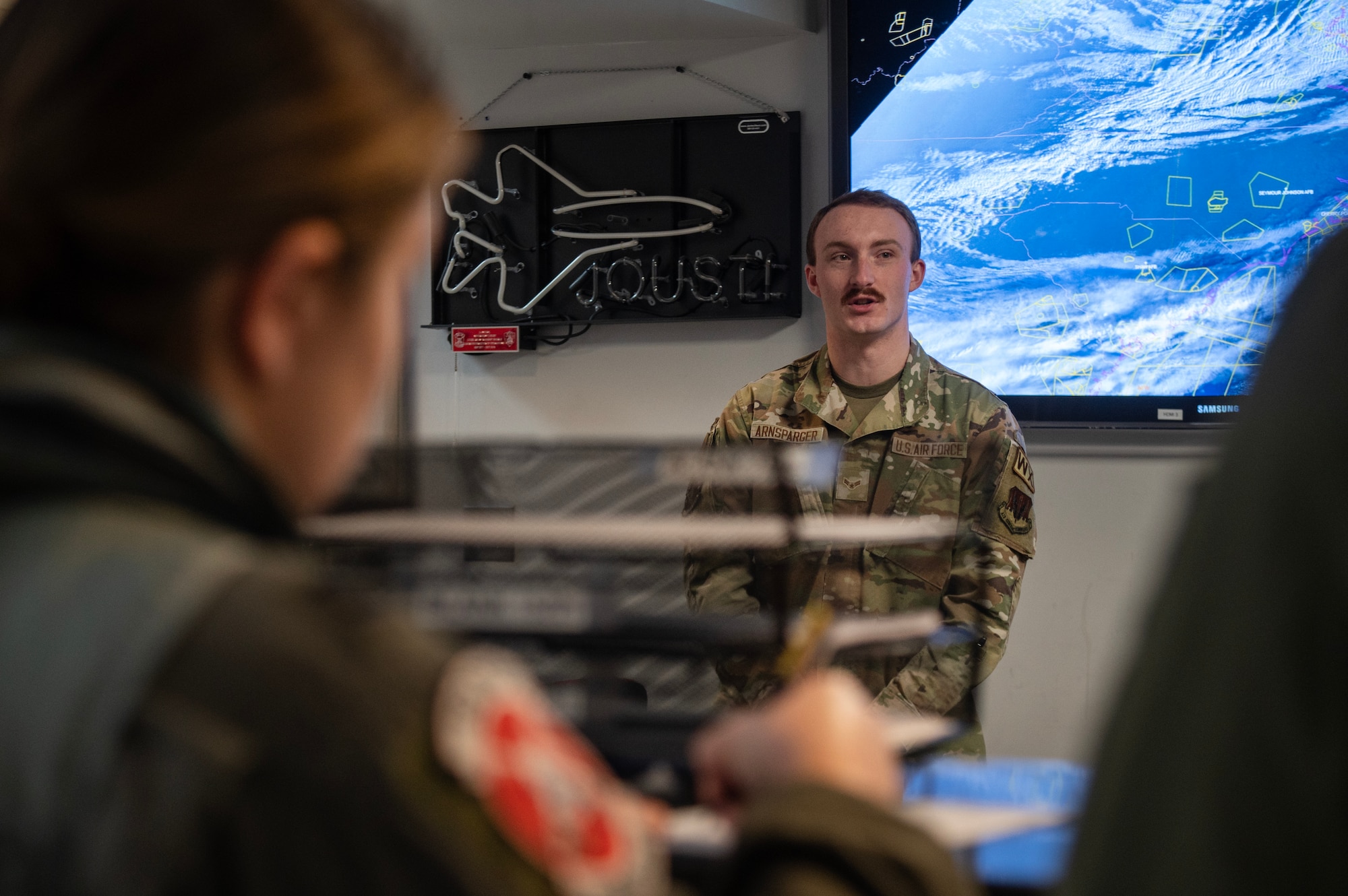 Airman 1st Class Jarvis Arnsparger, 4th Operations Support Squadron weather apprentice, briefs a weather forecast to aircrew.
