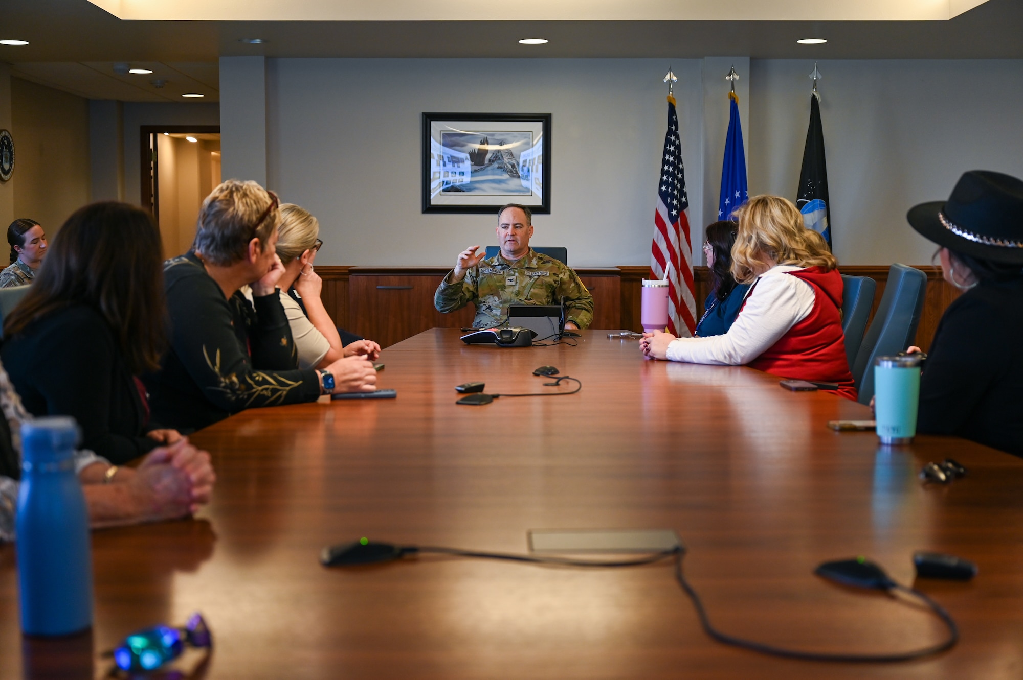 A group of people sit in a conference room.