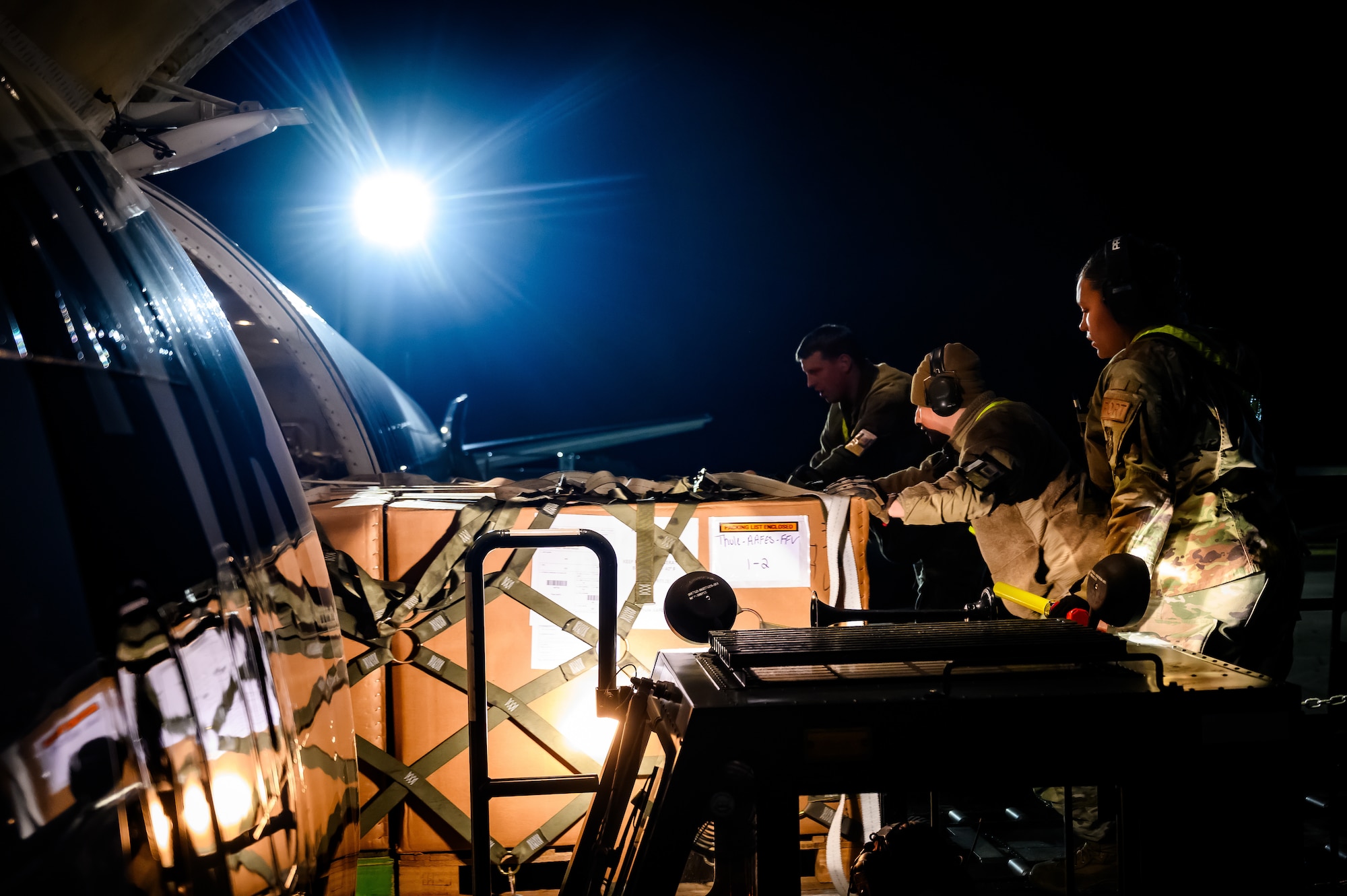 U.S. Air Force air transportation specialists assigned to the 305th Aerial Port Squadron, upload cargo onto a Boeing 757 aircraft at Joint Base McGuire-Dix-Lakehurst, N.J., Nov. 27, 2024. The 305th APS supports a channel mission to Pituffik Space Base in Greenland where essential goods are supplied sustain their mission. (U.S. Air Force photo by Senior Airman Matt Porter)