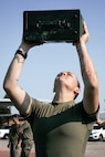U.S. Marine Corps Combat Graphics Specialist, Cpl. Alexandra Earl, with Headquarters and Service Battalion, Marine Corps Recruit Depot San Diego, conducts the ammunition can lift portion of a combat fitness test at MCRD San Diego, California, Dec. 4, 2024. The CFT is an annual fitness test that is required of all Marines to pass and maintain consisting of an 880-yard sprint, ammunition can lifts, and a maneuver under fire drill. (U.S. Marine Corps photo by Cpl. Sarah M. Grawcock)