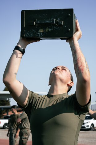 U.S. Marine Corps Combat Graphics Specialist, Cpl. Alexandra Earl, with Headquarters and Service Battalion, Marine Corps Recruit Depot San Diego, conducts the ammunition can lift portion of a combat fitness test at MCRD San Diego, California, Dec. 4, 2024. The CFT is an annual fitness test that is required of all Marines to pass and maintain consisting of an 880-yard sprint, ammunition can lifts, and a maneuver under fire drill. (U.S. Marine Corps photo by Cpl. Sarah M. Grawcock)
