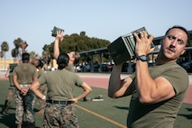 U.S. Marines with Headquarters and Service Battalion, Marine Corps Recruit Depot San Diego, conduct the ammunition can lift portion of a combat fitness test at MCRD San Diego, California, Dec. 4, 2024. The CFT is an annual fitness test that is required of all Marines to pass and maintain consisting of an 880-yard sprint, ammunition can lifts, and a maneuver under fire drill. (U.S. Marine Corps photo by Cpl. Sarah M. Grawcock)