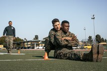 U.S. Marines with Headquarters and Service Battalion, Marine Corps Recruit Depot San Diego, conduct the maneuver under fire portion of a combat fitness test at MCRD San Diego, California, Dec. 4, 2024. The CFT is an annual fitness test that is required of all Marines to pass and maintain consisting of an 880-yard sprint, ammunition can lifts, and a maneuver under fire drill. (U.S. Marine Corps photo by Cpl. Sarah M. Grawcock)