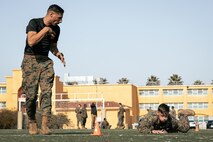 U.S. Marine Corps Training Chief, Staff Sgt. Jeffrey Gomez Jr., and Operations Chief with Communication Strategy and Operations, Sgt. Jesse Carter-Powell, both with Headquarters and Service Battalion, Marine Corps Recruit Depot San Diego, conducts the maneuver under fire portion of a combat fitness test at MCRD San Diego, California, Dec. 4, 2024. The CFT is an annual fitness test that is required of all Marines to pass and maintain consisting of an 880-yard sprint, ammunition can lifts, and a maneuver under fire drill. (U.S. Marine Corps photo by Cpl. Sarah M. Grawcock)