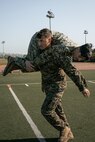 U.S. Marine Corps Operations Chief with Communication Strategy and Operations, Sgt. Jesse Carter-Powell, center, and Combat Photographer, Lance Cpl. Jacob Hutchinson, both with Headquarters and Service Battalion, Marine Corps Recruit Depot San Diego, conducts the maneuver under fire portion of a combat fitness test at MCRD San Diego, California, Dec. 4, 2024. The CFT is an annual fitness test that is required of all Marines to pass and maintain consisting of an 880-yard sprint, ammunition can lifts, and a maneuver under fire drill. (U.S. Marine Corps photo by Cpl. Sarah M. Grawcock)
