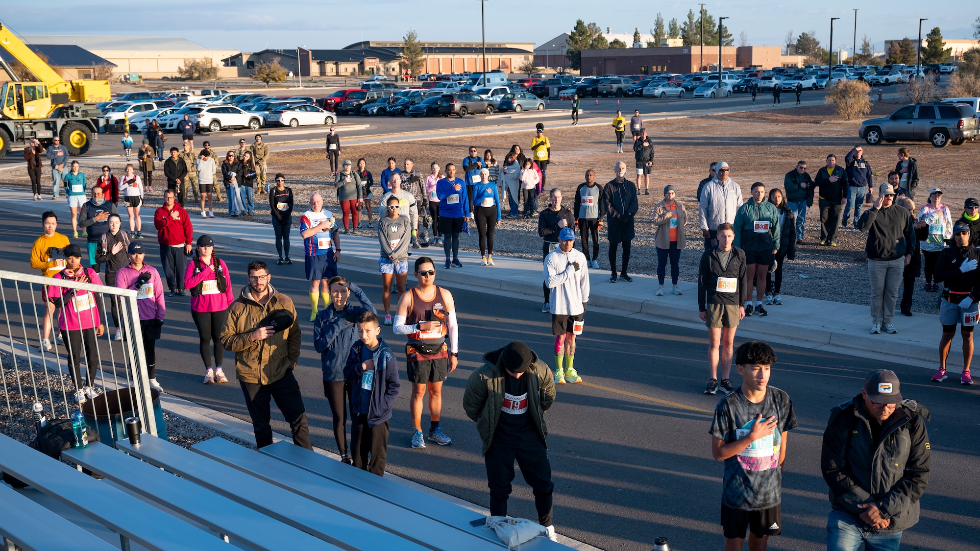 Participants of the 2nd annual Ace of Races Marathon stand for the playing of the national anthem prior to the beginning of the race at Holloman Air Force Base, New Mexico, Dec. 7, 2024.