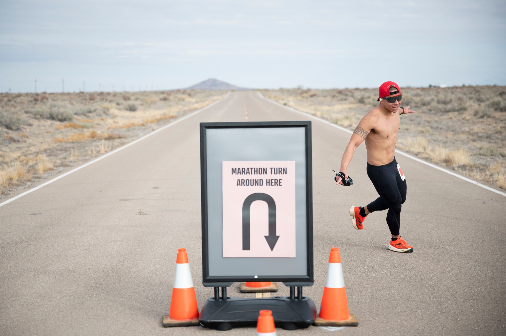 U.S. Air Force Senior Airman Reubhen Delfin, of the 9th Special Operations Aircraft Maintenance Squadron at Cannon Air Force Base, New Mexico, rounds the halfway point of the 2nd annual Ace of Races Marathon at Holloman Air Force Base, New Mexico, Dec. 7, 2024.