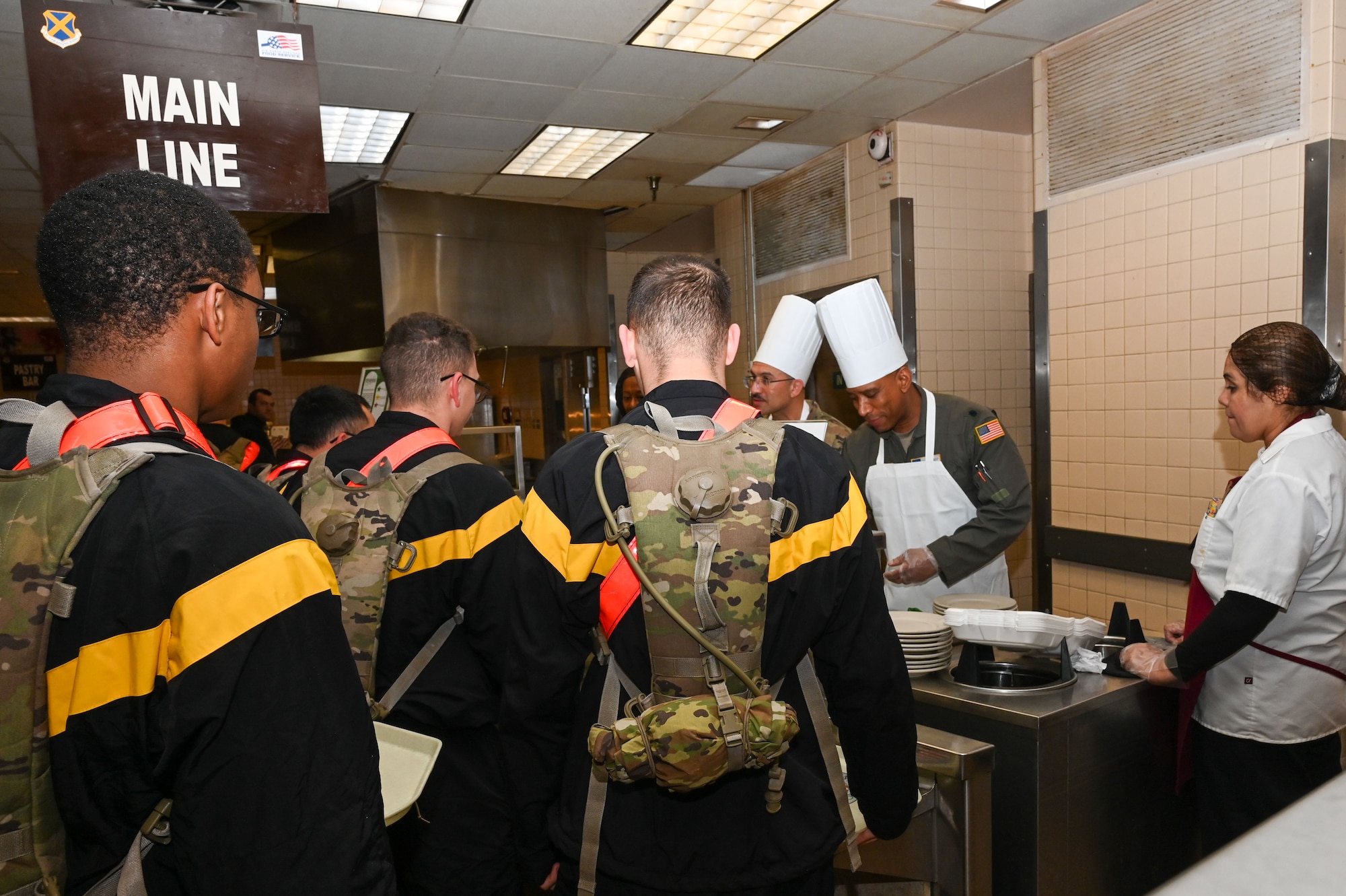 Senior leaders from the 433rd Alamo Wing serve meals to service members during the “Feed the Troops” event at the Live Oak Dining Facility on Joint Base San Antonio-Lackland, Texas, Dec. 7, 2024.
