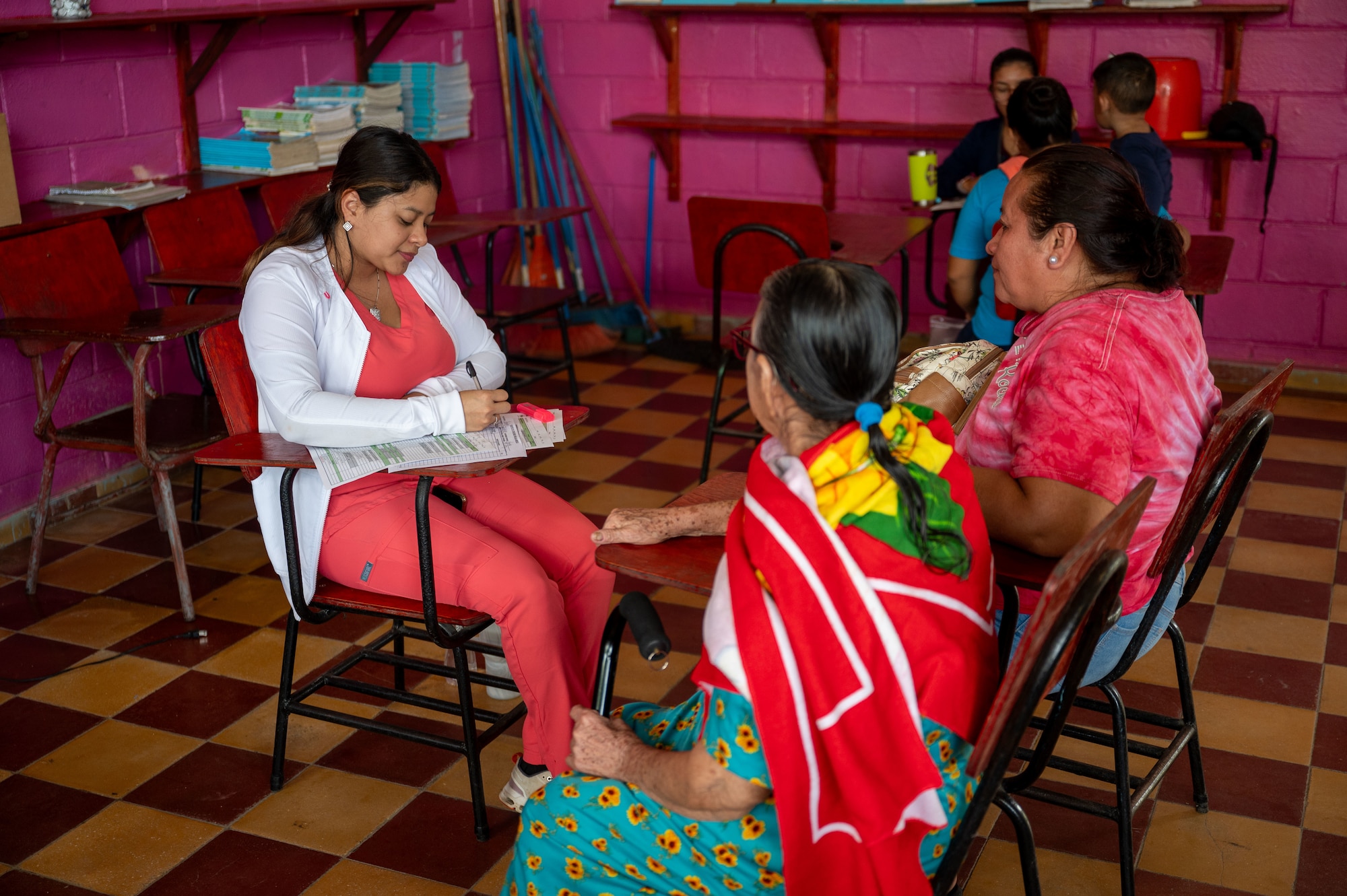 A member of the Honduran medical team provides general medical care to a Honduran woman her mother during an Army Force Battalion, JTF- Bravo mission near Tela, Honduras. Over three days, 18 service members from Army Forces Battalion, Joint Task Force-Bravo, alongside more than 50 Honduran counterparts, provided health care services to 835 Hondurans living in the vicinity of Tela, Honduras, Dec. 3 through 5, 2024. (U.S. Air Force photo)