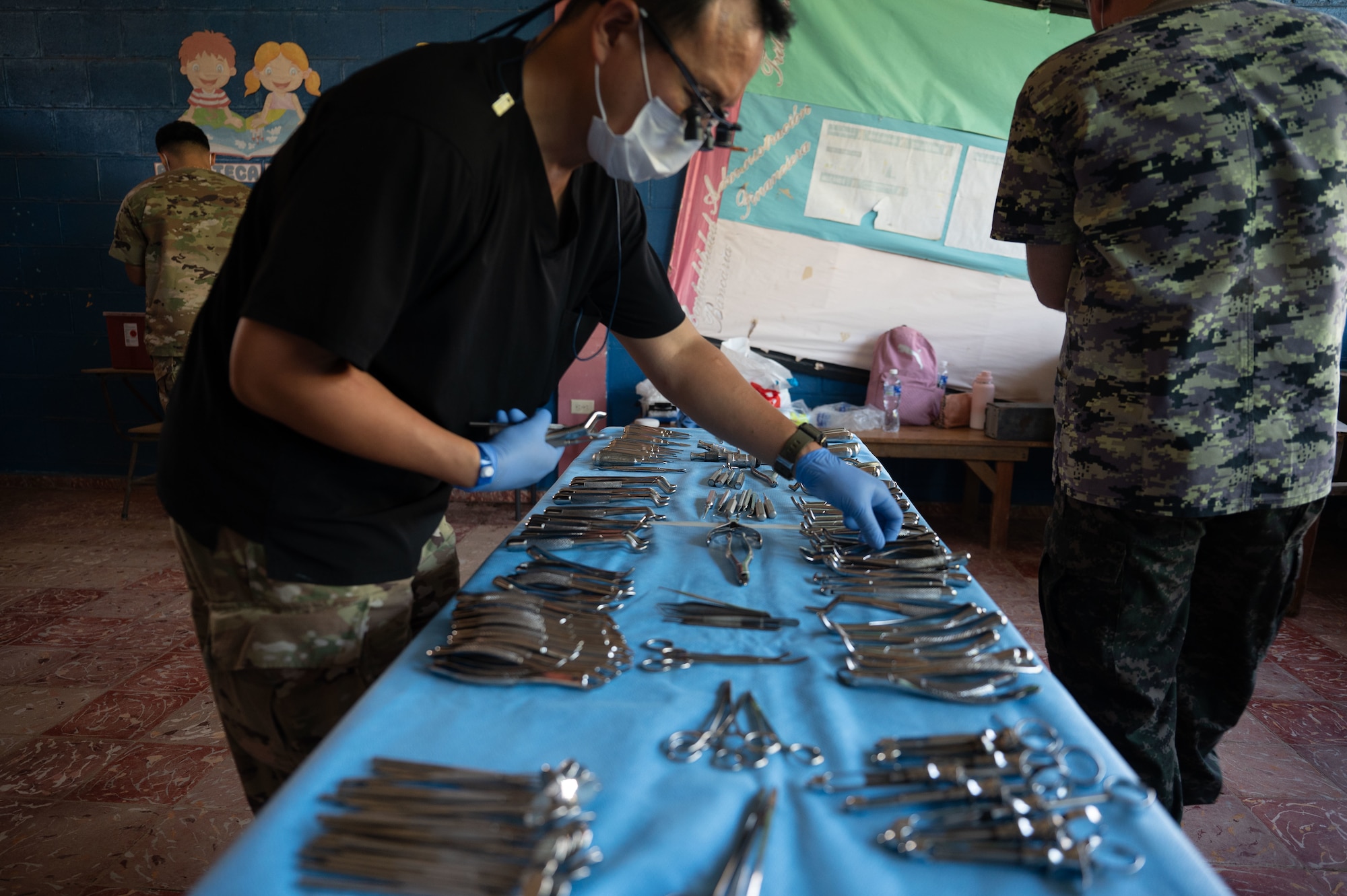 Maj. Jae Park, a dental officer assigned to Army Forces Battalion, prepares to provide dental care to a patient during a medical mission near Tela, Honduras. Over three days, 18 service members from Army Forces Command, Joint Task Force-Bravo, alongside more than 50 Honduran counterparts, provided health care services to 835 Hondurans living in the vicinity of Tela, Honduras, Dec. 3 through 5, 2024. (U.S. Air Force photo)