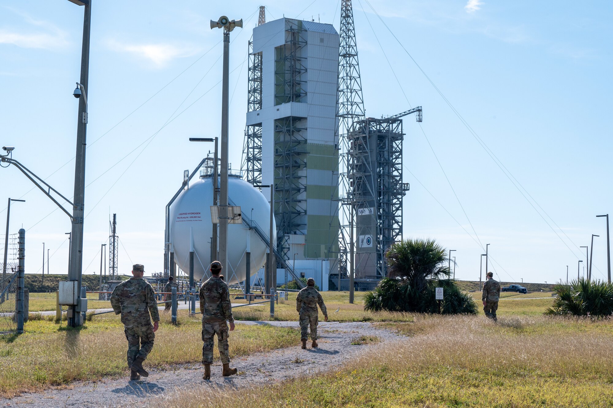 Members of SLD 45 walk through a field.