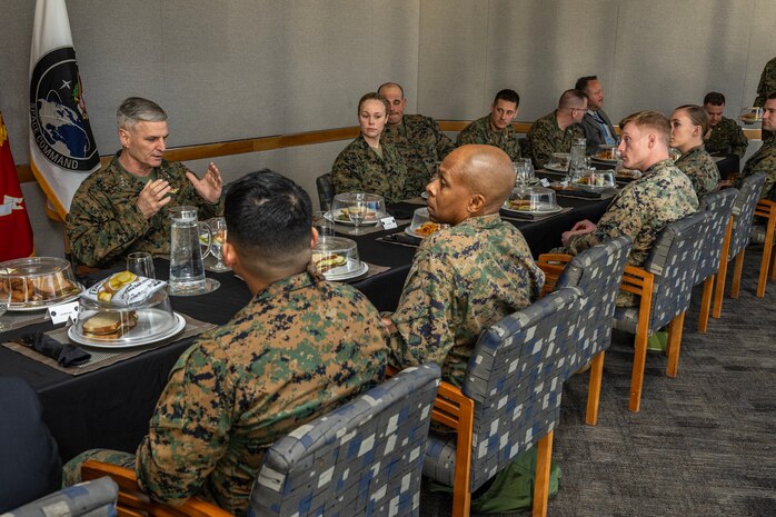 The 37th Assistant Commandant of the Marine Corps, Gen. Christopher J. Mahoney, eats lunch with U.S. Marines assigned to U.S. Space Command’s U.S. Marine Corps Forces Space Command at Peterson Space Force Base, Colo., Feb. 14, 2024. In addition to informational briefings from USSPACECOM senior leaders, the visit underscored the current state of the threats in space and provided insight on the unique contributions of the space domain to the joint warfighter.  USSPACECOM, working with Allies and Partners, plans, executes, and integrates military space power into multi-domain global operations in order to deter aggression, defend national interests and defeat threats when necessary. (USSPACECOM photo by Mass Communication Specialist 1st Class John Philip Wagner Jr.)