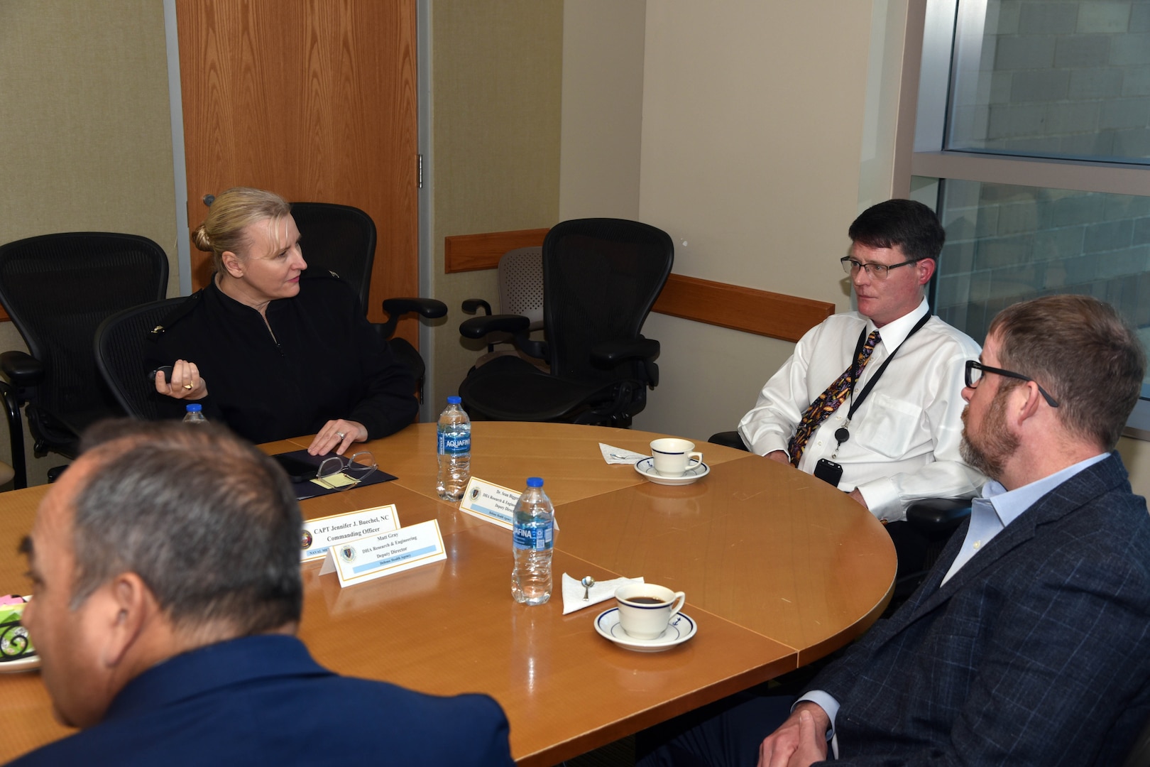 JOINT BASE SAN ANTONO-FORT SAM HOUSTON - (Dec. 10, 2024) – Commanding Officer Capt. Jennifer Buechel, Nurse Corps, of Naval Medical Research Unit (NAMRU) San Antonio, briefs the unit’s mission to Dr. Sean Biggerstaff, principal deputy director, and Matt Gray, deputy director, Research and Engineering Directorate, Defense Health Agency (DHA) at the Battlefield Health and Trauma Research Institute. Biggerstaff and Gray visited with leadership and staff of Naval Medical Research Unit (NAMRU) San Antonio to discussed prioritization of research priorities and the importance of building relationships in reference to funding of core capabilities and fiscal responsibilities. NAMRU San Antonio's mission is to conduct gap driven combat casualty care, craniofacial, and directed energy research to improve survival, operational readiness, and safety of Department of Defense (DoD) personnel engaged in routine and expeditionary operations. It is one of the leading research and development laboratories for the U.S. Navy under the DoD and is one of eight subordinate research commands in the global network of laboratories operating under the Naval Medical Research Command in Silver Spring, Md. (U.S. Navy photo by Burrell Parmer, NAMRU San Antonio Public Affairs/Released)