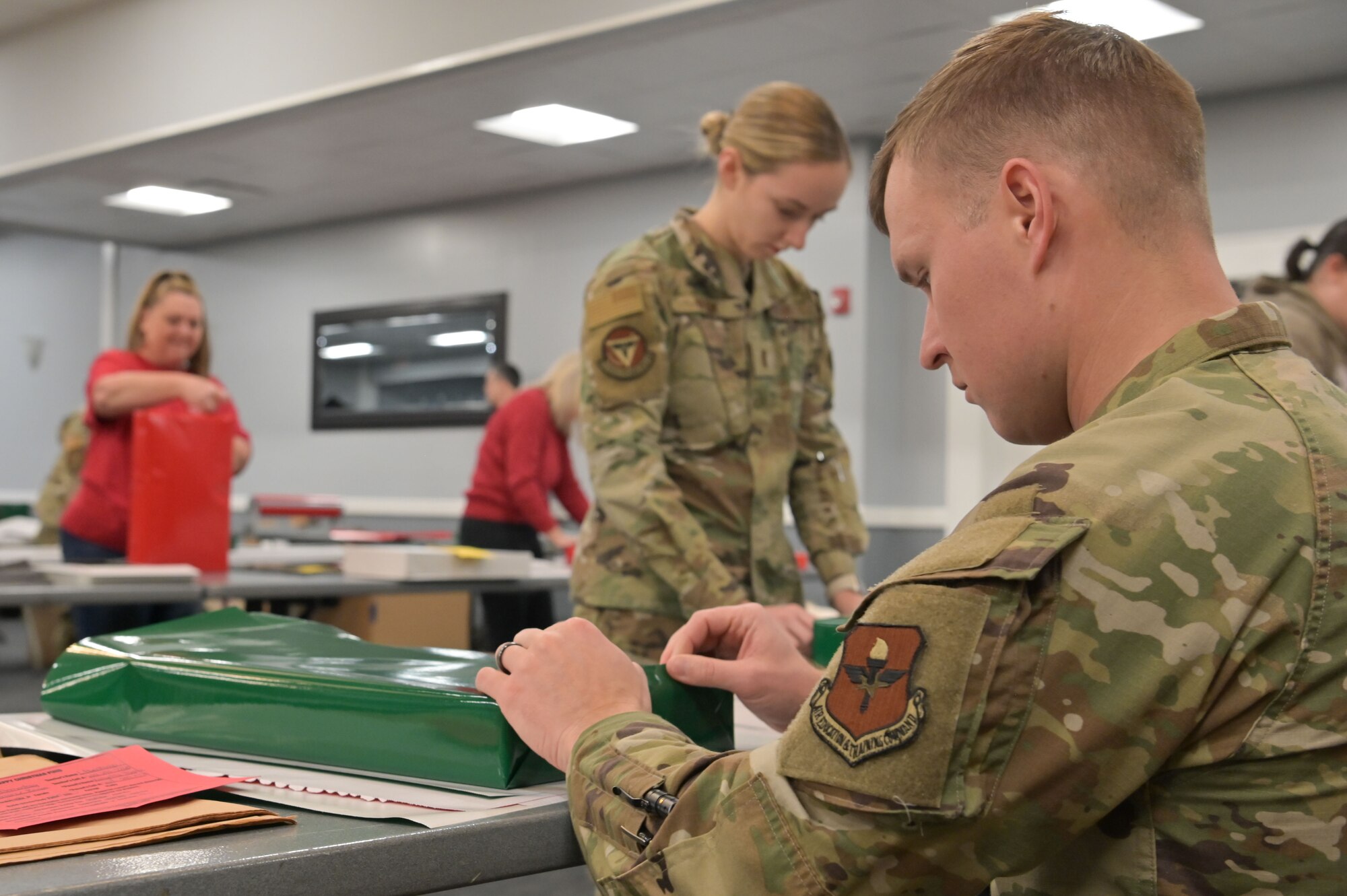 Columbus Air Force Base Airmen wrap donated gifts at the Columbus Air Force Base Event Center on Columbus Air Force Base, Dec. 11, 2024.