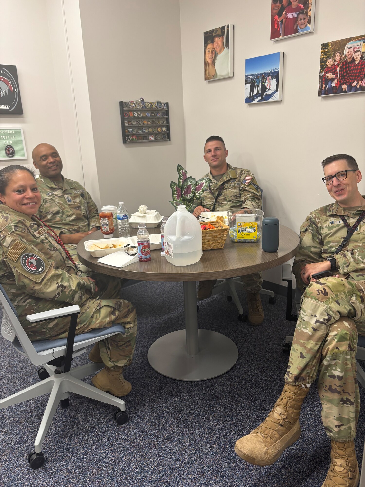 Uniformed members sit at a table.