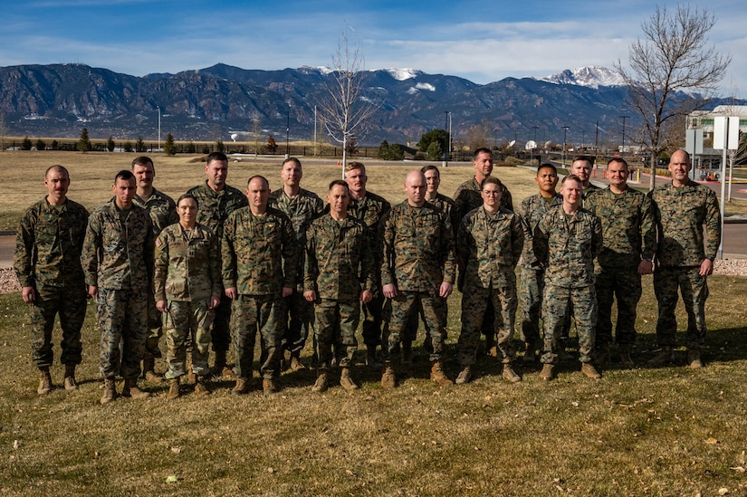 Personnel assigned to Marine Corps Information Command, Marine Forces Space Command, and United States Space Command pose for a group photo during the Fire Support Rehearsal Exercise (FSRE) at Colorado Springs, Colorado, Nov. 22, 2024. The FSRE served as a critical testbed for space officers and fires practitioners from around the U.S. Armed Forces to integrate space effects with ground schemes of maneuver. (U.S. Navy Courtesy Photo)