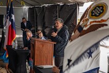 Man stands behind a podium while speaking
