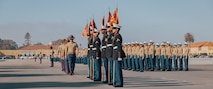 U.S. Marine Corps drill instructors with Kilo Company, 3rd Recruit Training Battalion, march to retire the guidons during a graduation ceremony at Marine Corps Recruit Depot San Diego, California, Dec. 6, 2024. This ceremony marked the end of a 13-week transformation that included training in drill, marksmanship, basic combat skills, and Marine Corps customs and traditions. (U.S. Marine Corps photo by Lance Cpl. Janell B. Alvarez)