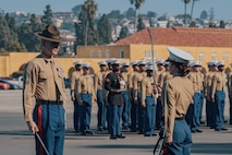 The Company First Sergeant for Kilo Company, 3rd Recruit Training Battalion, U.S. Marine Corps 1st Sgt. Christopher Thomas, left, receives permission to dismiss the company by the Commanding Officer for Kilo Company, 3rd Recruit Training Battalion, U.S. Marine Corps Capt. Nikole Tavenner, during a graduation ceremony at Marine Corps Recruit Depot San Diego, California, Dec. 6, 2024. This ceremony marked the end of a 13-week transformation that included training in drill, marksmanship, basic combat skills, and Marine Corps customs and traditions. (U.S. Marine Corps photo by Lance Cpl. Janell B. Alvarez)