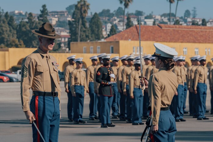 The Company First Sergeant for Kilo Company, 3rd Recruit Training Battalion, U.S. Marine Corps 1st Sgt. Christopher Thomas, left, receives permission to dismiss the company by the Commanding Officer for Kilo Company, 3rd Recruit Training Battalion, U.S. Marine Corps Capt. Nikole Tavenner, during a graduation ceremony at Marine Corps Recruit Depot San Diego, California, Dec. 6, 2024. This ceremony marked the end of a 13-week transformation that included training in drill, marksmanship, basic combat skills, and Marine Corps customs and traditions. (U.S. Marine Corps photo by Lance Cpl. Janell B. Alvarez)