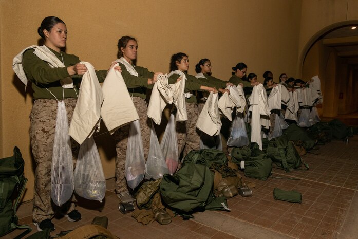 U.S. Marine Corps recruits with India Company, 3rd Recruit Training Battalion, are given instructions during a receiving event at Marine Corps Recruit Depot San Diego, California, Dec. 2, 2024. During the receiving process, recruits are taken to the United Service Organizations for accountability, checked for contraband, given haircuts, make a scripted phone call home, and issued gear required for training. (U.S. Marine Corps photo by Lance Cpl. Janell B. Alvarez)