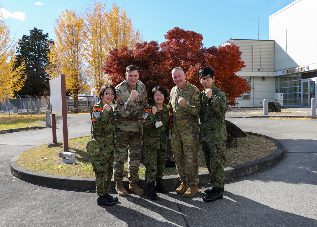 U.S. Army Maj. Gen. David B. Womack, center left, Commanding General of U.S. Army Japan, Australian Army Maj. Gen. Scott Winter, center right, the Deputy Commanding General - Strategy and Plans for the U.S. Army Pacific and Japan Ground Self-Defense Force service members, pose for a photo during Yama Sakura 87 at Sagami General Depot, Japan, Dec. 8, 2024.